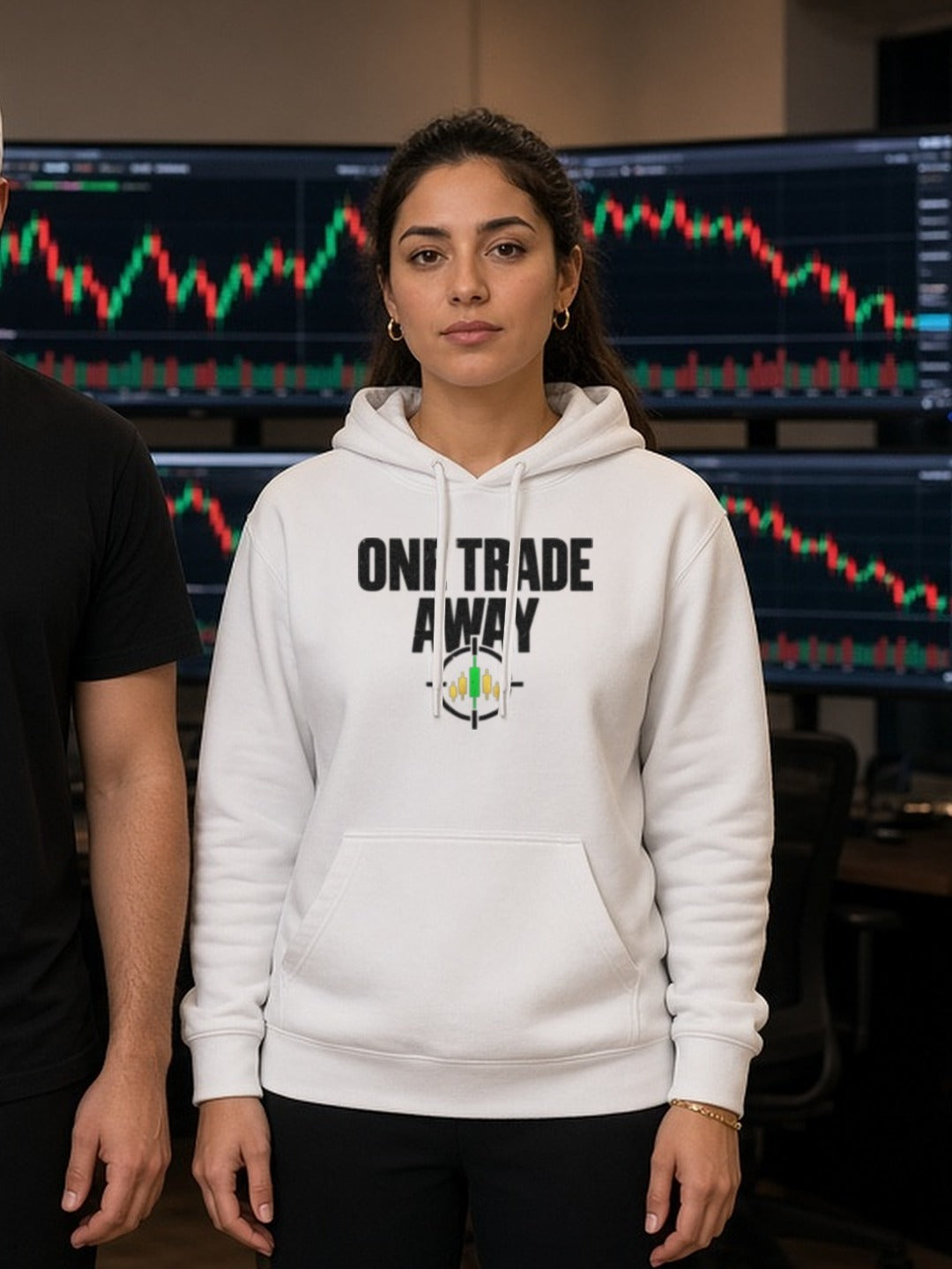 Trader wearing a white One Trade Away hoodie at her trading desk