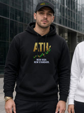Load image into Gallery viewer, ATH Hoodie in black worn by a trader on a city street, with a Funded dad hat