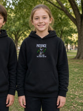 Load image into Gallery viewer, Kids Patience Hoodie in black worn by a girl in a park