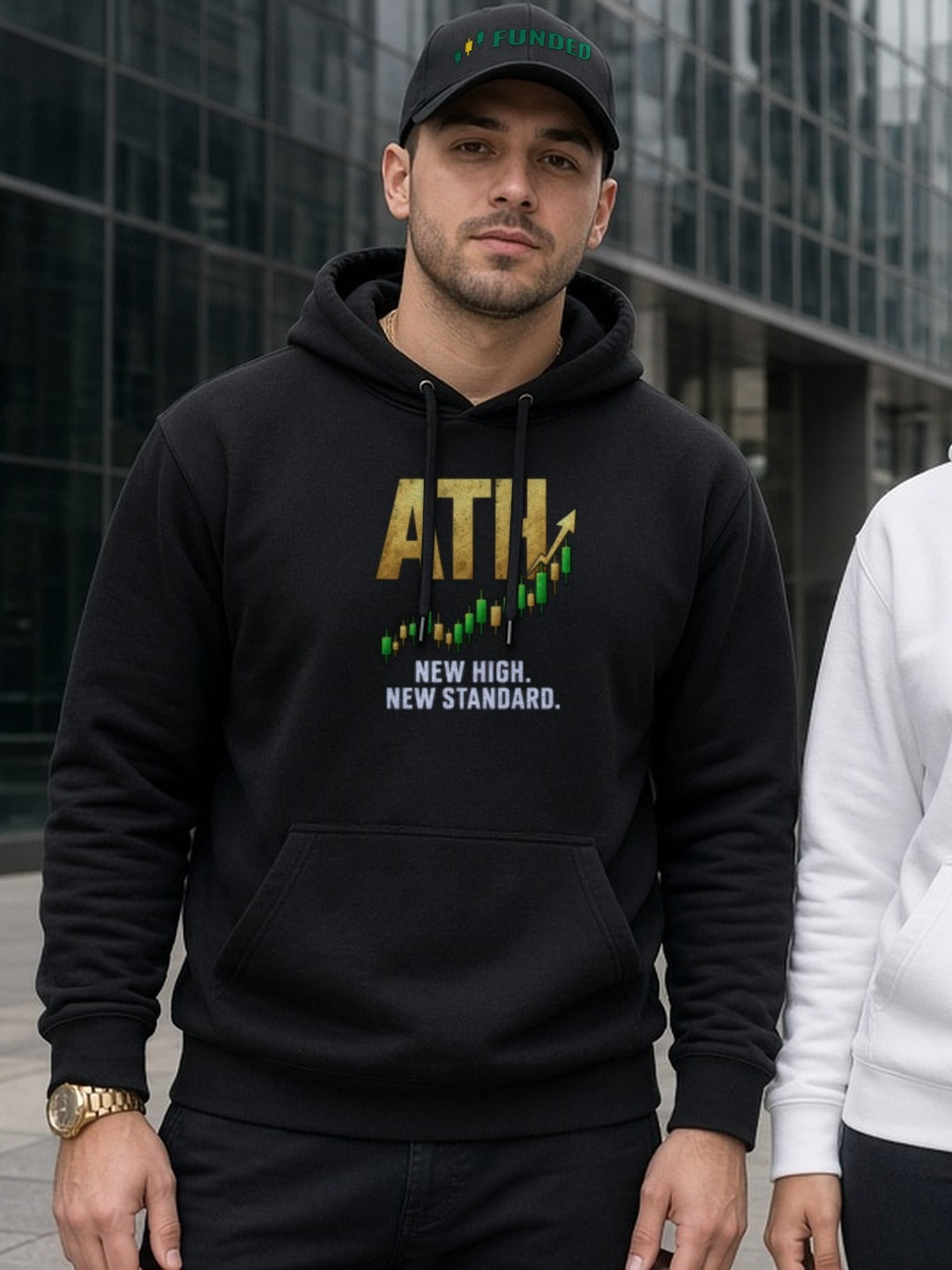 Trader wearing an ATH hoodie and Funded dad hat on a city street